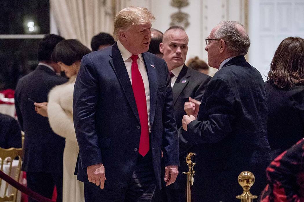 President Donald Trump speaks to attorney Alan Dershowitz, right, as he arrives for Christmas E ...