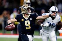 New Orleans Saints quarterback Drew Brees (9) scrambles to pass in the first half of an NFL foo ...