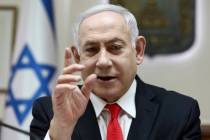 Israeli Prime Minister Benjamin Netanyahu reacts during the weekly cabinet meeting, at his offi ...