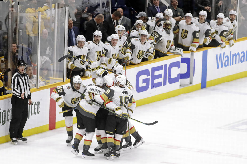 Vegas Golden Knights players celebrate after Max Pacioretty scored the tying goal against the N ...