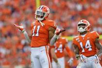 In this Oct. 12, 2019, file photo, Clemson's Isaiah Simmons (11) and Denzel Johnson react after ...