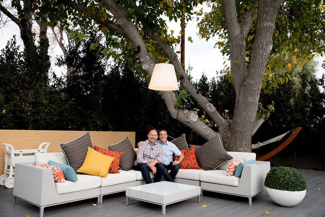 Architects John Klai and Jon Sparer sit in the backyard of their 1950s midcentury home they rem ...