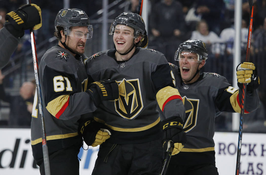 Vegas Golden Knights center Cody Glass, center, celebrates with Mark Stone, left, and Paul Stas ...