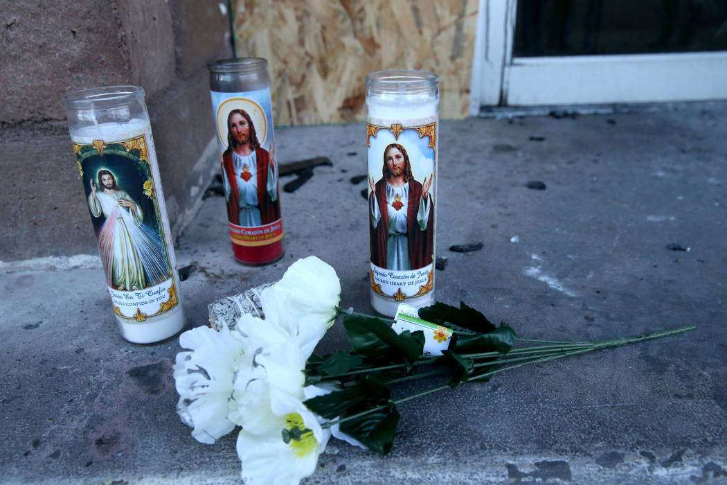 Flowers and candles at the Alpine Motel Apartments Wednesday, Dec. 25, 2019, after six people d ...