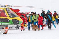 Rescue forces and helicopters search for missing people after an avalanche swept down a ski pis ...