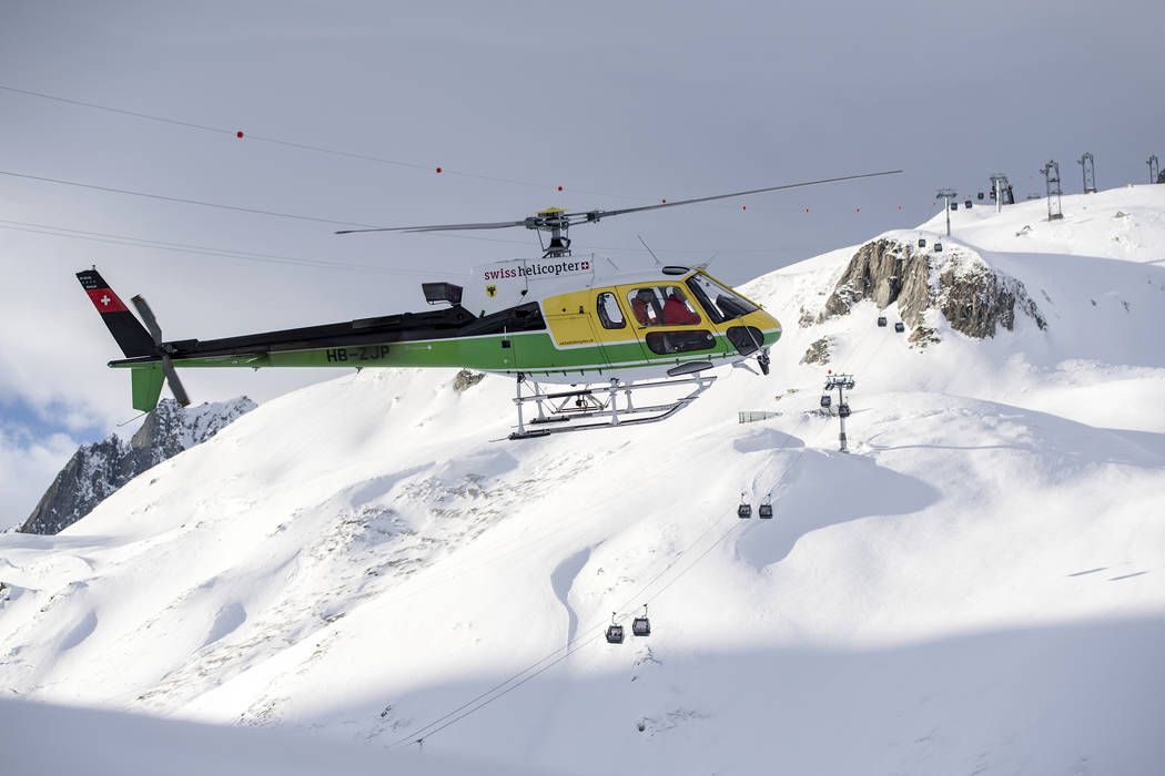 Rescue forces and helicopters search for missing people after an avalanche swept down a ski pis ...