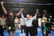 Tyson Fury, left, of England, poses with Deontay Wilder, right, along with referee Jack Reiss a ...