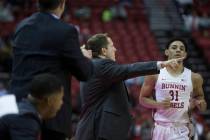 UNLV Rebels head coach T.J. Otzelberger, middle, gives direction to UNLV Rebels guard Marvin Co ...