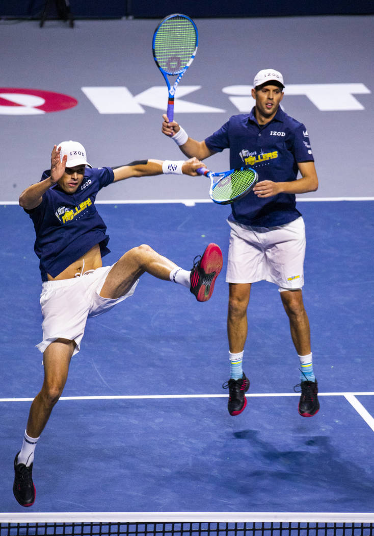 The Vegas Rollers' Bob and Mike Bryan come together after a shot during their men's doubles set ...
