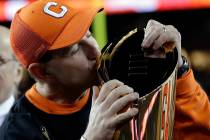Clemson head coach Dabo Swinney kisses the championship trophy in Santa Clara, Calif., in Janua ...