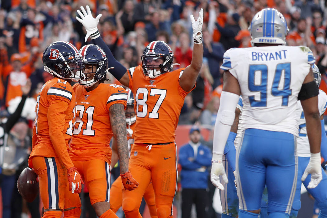 Denver Broncos wide receiver DaeSean Hamilton, left, celebrates his touchdown against the Detro ...