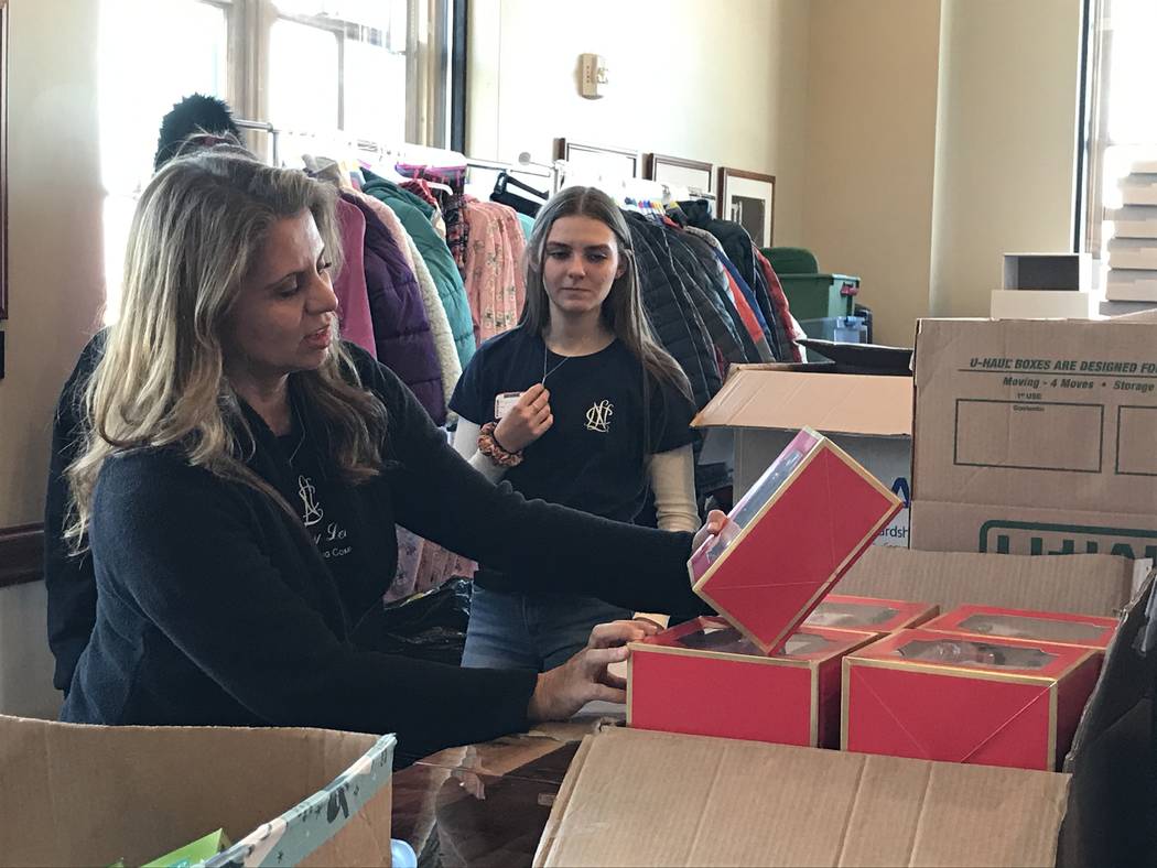 Volunteers work Saturday at the Mob Museum to sort donated items brought in through a Downtown ...