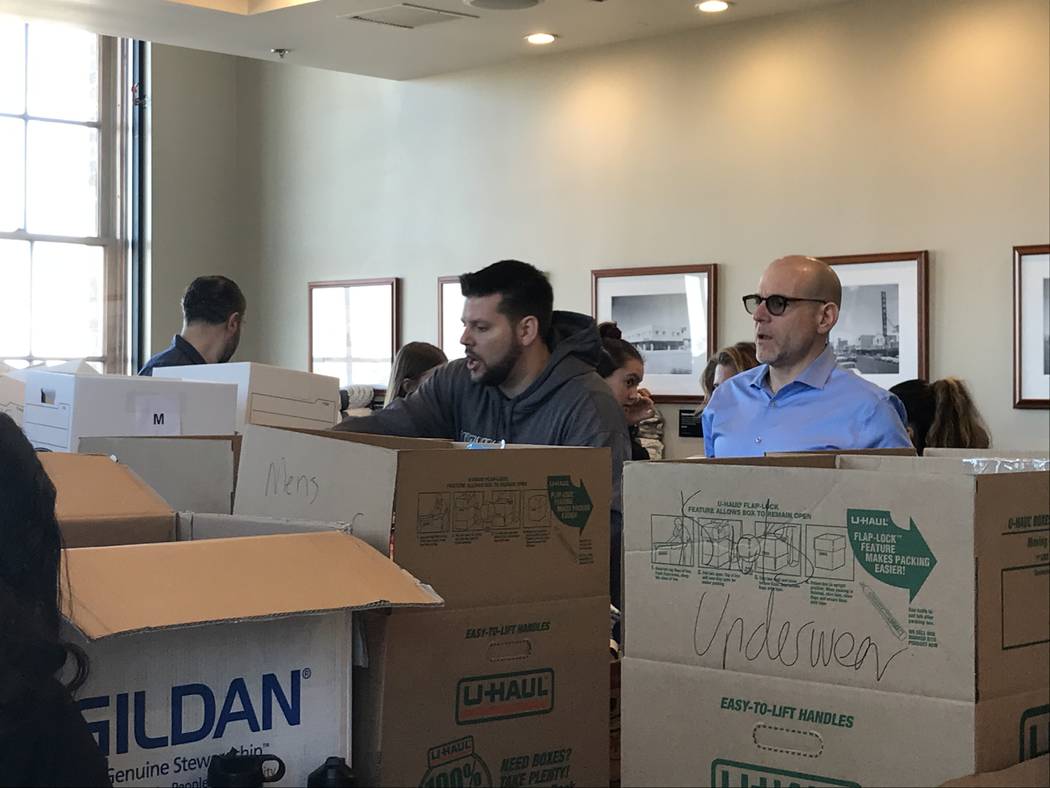 Volunteers work Saturday at the Mob Museum to sort donated items brought in through a Downtown ...