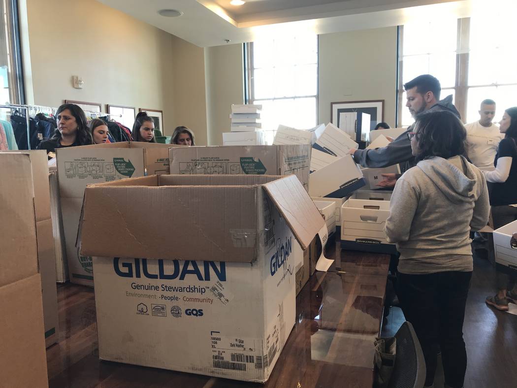 Volunteers work Saturday at the Mob Museum to sort donated items brought in through a Downtown ...