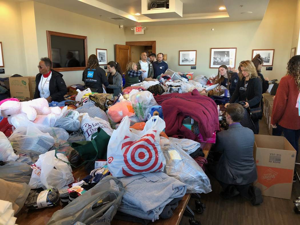 Volunteers work Saturday at the Mob Museum to sort donated items brought in through a Downtown ...