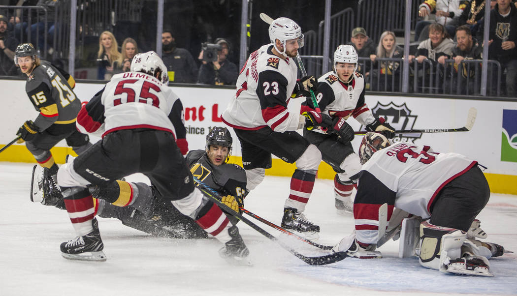 Vegas Golden Knights left wing Max Pacioretty (67, center) is down on the ice but still shoots ...