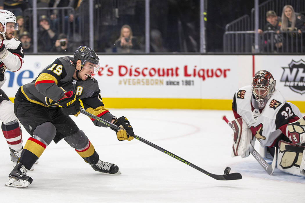 Vegas Golden Knights right wing Reilly Smith (19) sends a shot attempt on Arizona Coyotes goalt ...