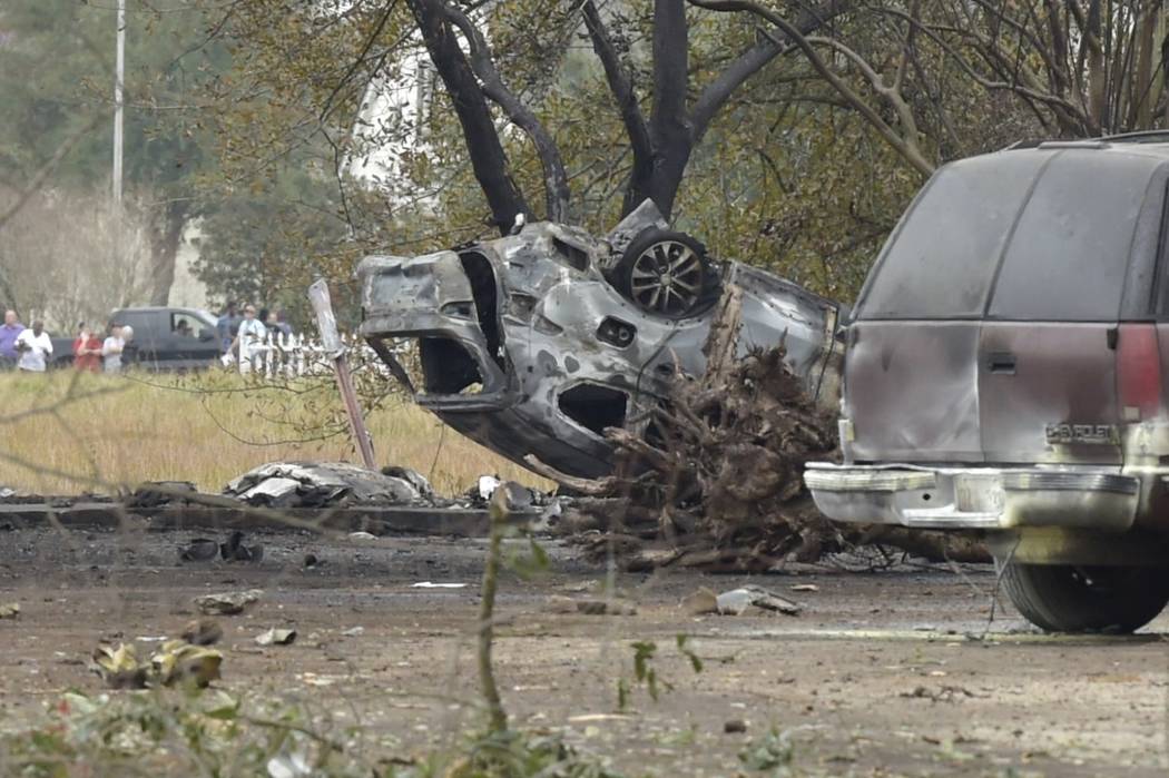 A view of a damaged vehicle near the site of a plane crash near Feu Follet Road and Verot Schoo ...