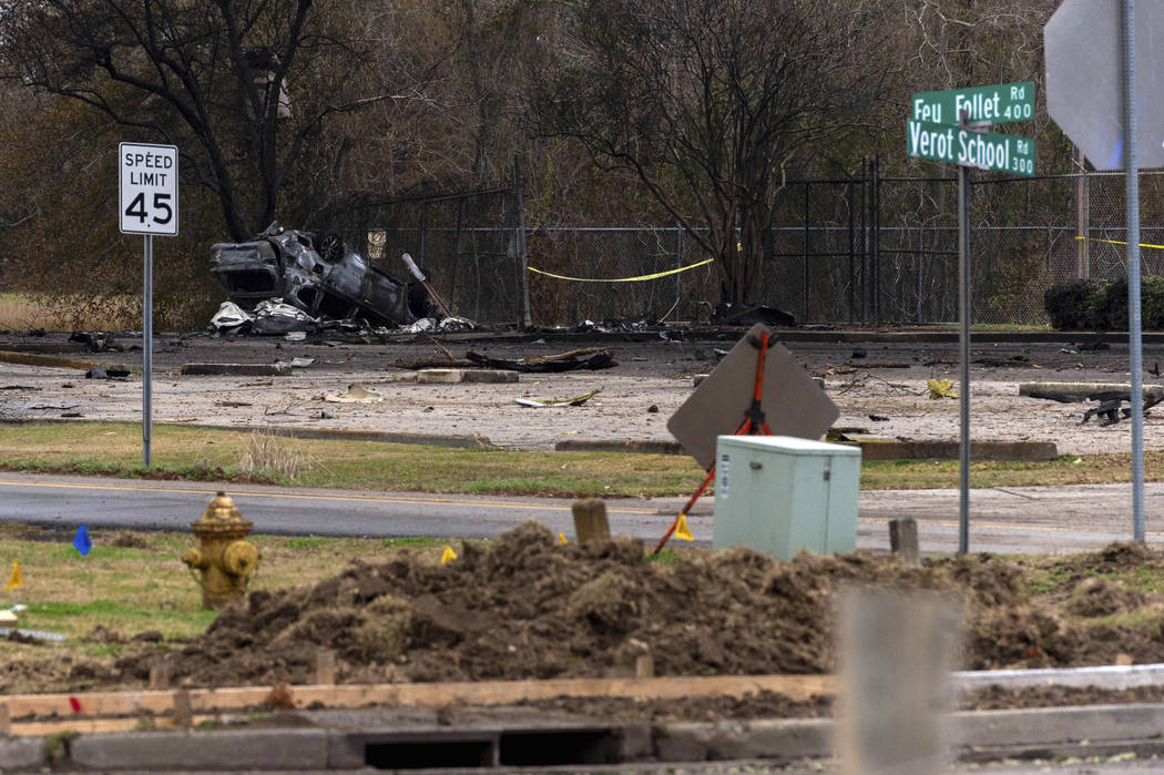 A view of a damaged vehicle near the site of a plane crash after a small plane crashed into the ...