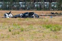 A view of the burnt wreckage after a small plane crashed into the parking lot of a post office ...