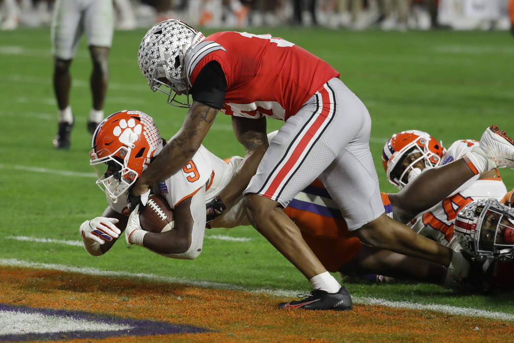 Clemson running back Travis Etienne scores against Ohio State during the second half of the Fie ...