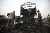 Afghan laborers work at a charcoal market on the outskirts of Kabul, Afghanistan, Wednesday, De ...