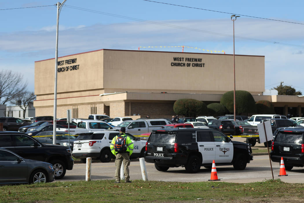 A person stands near the scene of a church shooting at West Freeway Church of Christ on Sunday, ...