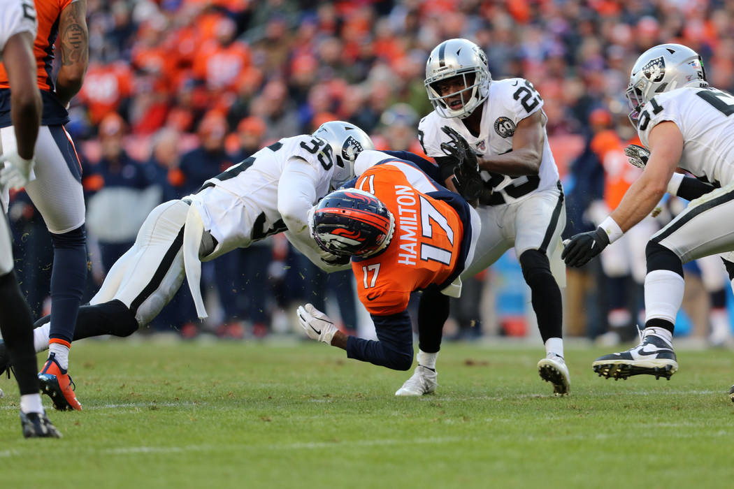 Oakland Raiders free safety Curtis Riley (35) tackles Denver Broncos wide receiver DaeSean Hami ...