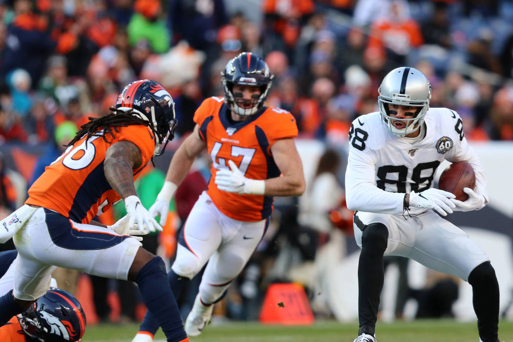 Oakland Raiders wide receiver Marcell Ateman (88) makes a catch as Denver Broncos defenders Tre ...