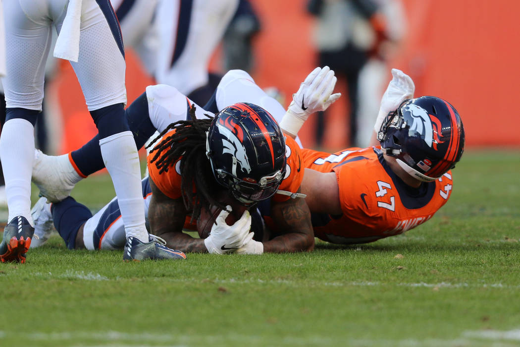 Denver Broncos defensive back Trey Marshall (36) recovers a fumble made by Oakland Raiders wide ...