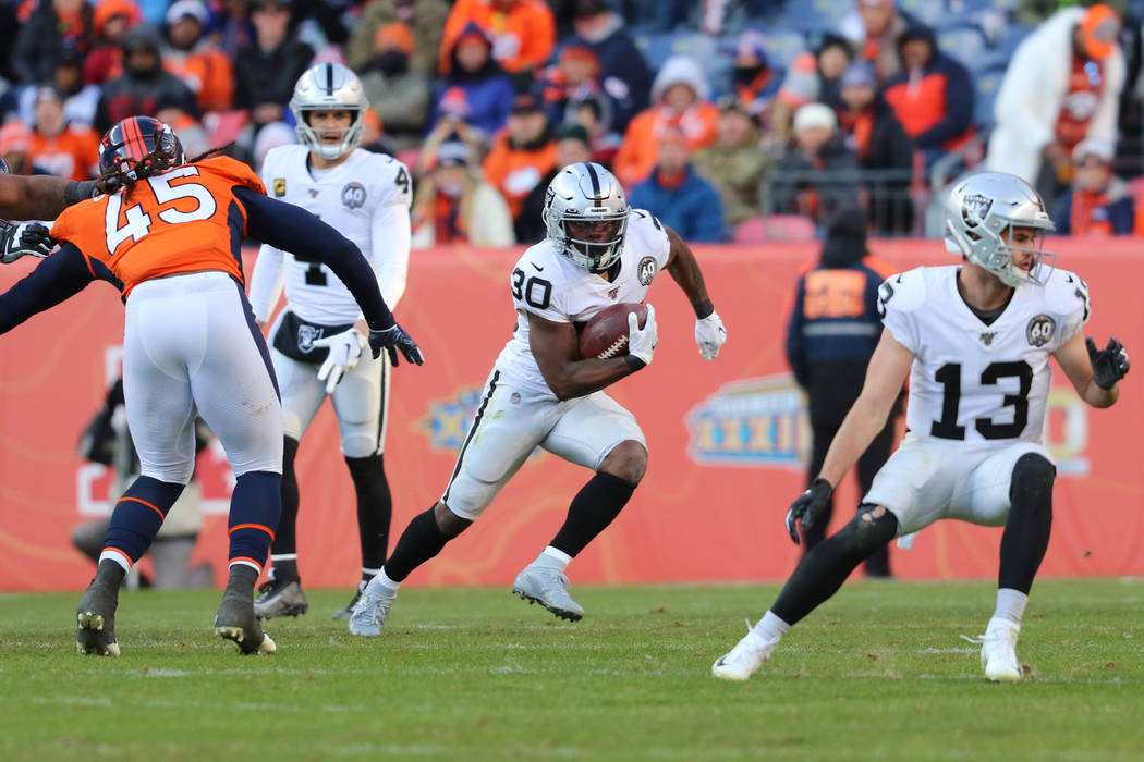 Oakland Raiders running back Jalen Richard (30) looks for open field to run as quarterback Dere ...