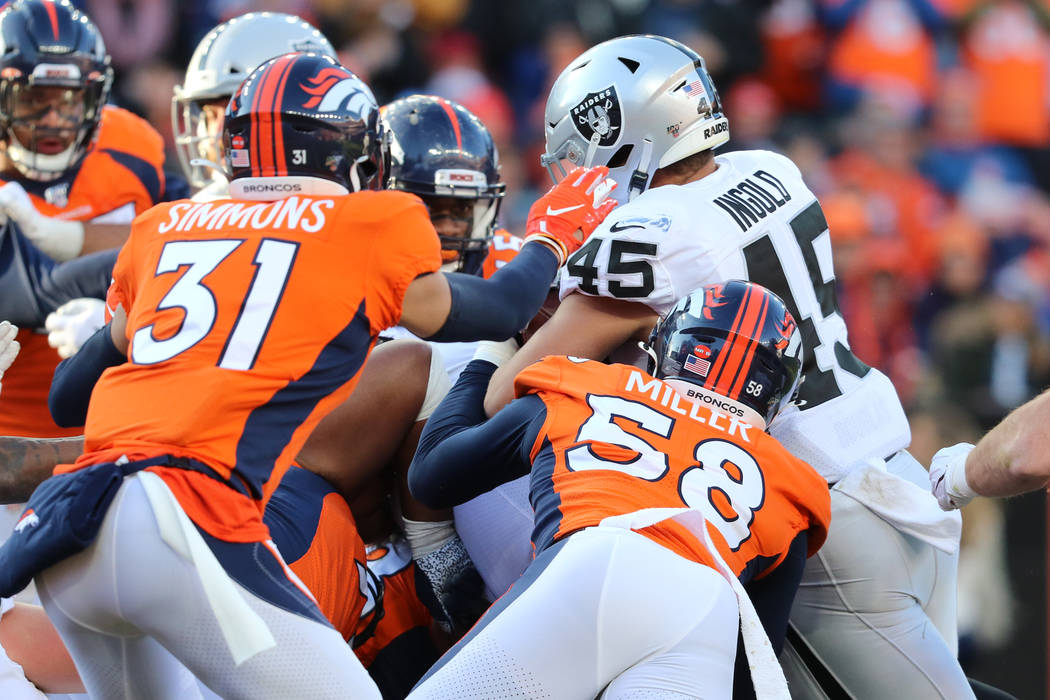 Oakland Raiders fullback Alec Ingold (45) tries to cross into the end zone for a score as Denve ...