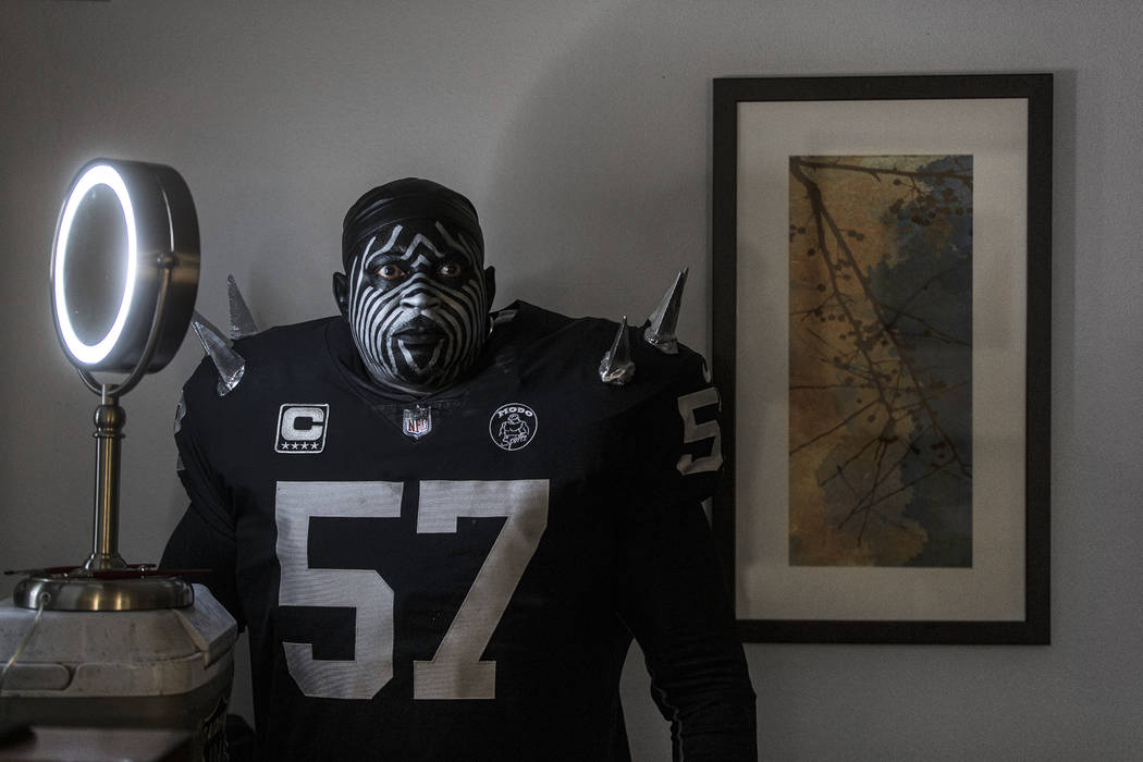 Raiders super fan Wayne Mabry, known as "Violator," takes a moment to reflect in his ...