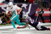 Miami Dolphins tight end Mike Gesicki, left, catches the winning touchdown pass in front of New ...
