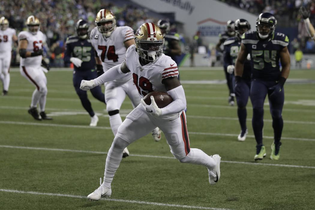 San Francisco 49ers wide receiver Deebo Samuel scores on a 30-yard run against the Seattle Seah ...
