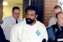 Grafton Thomas is led from Ramapo Town Hall in Ramapo, N.Y. following his arraignment Sunday, D ...