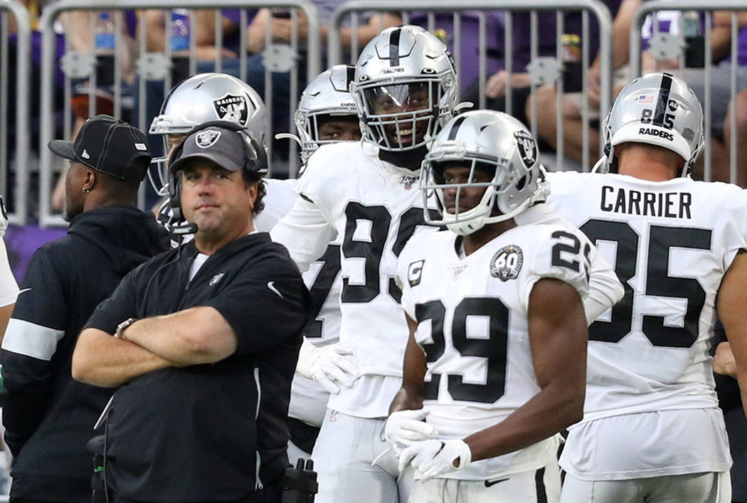 Oakland Raiders defensive coordinator Paul Guenther stares with his arms folded during the four ...