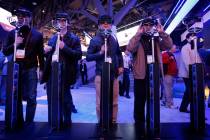 Showgoers try out 3D glasses at the Panasonic booth during the 2010 Consumer Electronics Show. ...