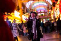 Tammy Dinh of San Diego, Calif., poses for a photo as New Year's Eve revelers gather at the Fre ...