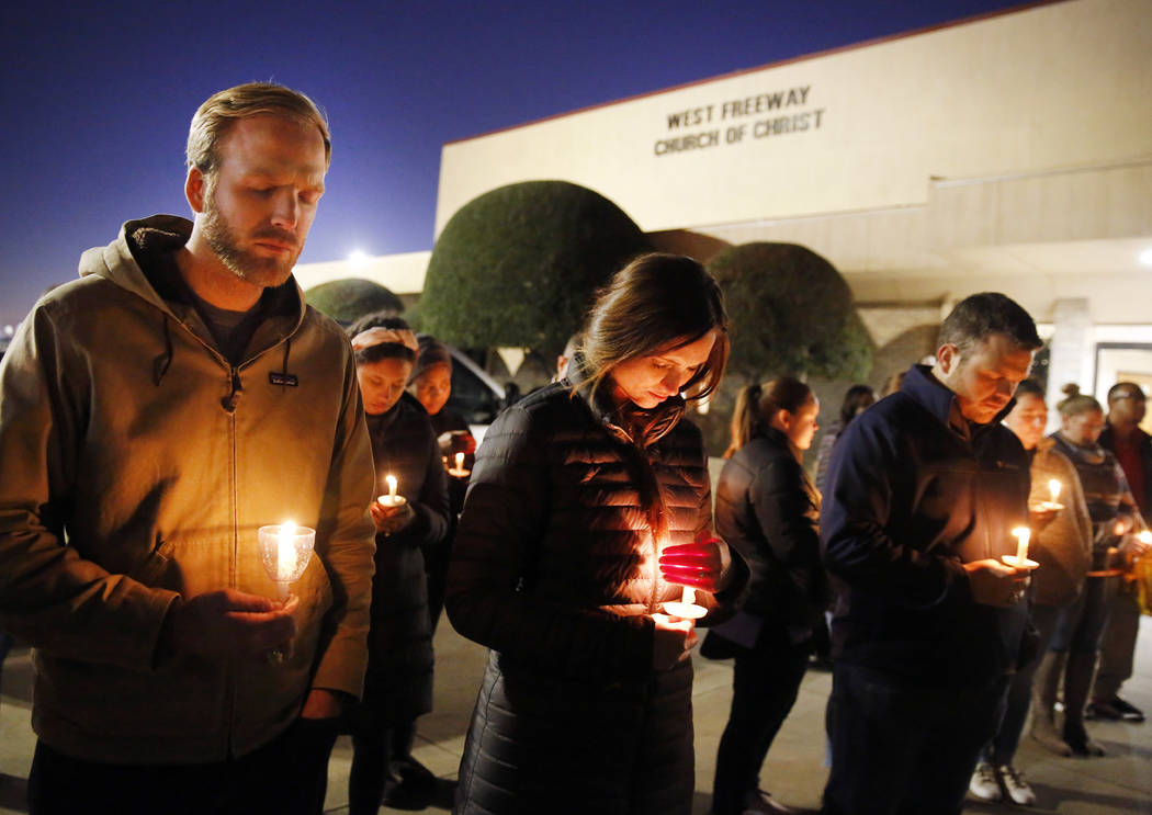 Church and community members, including Matt Pacholczyk, left, and his wife, Faith Pacholczyk, ...