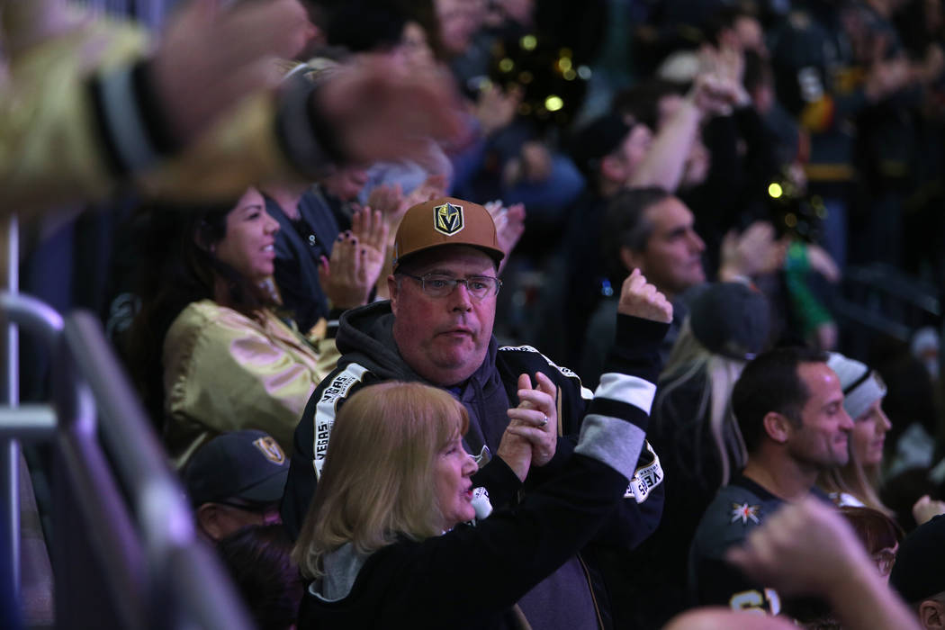 Fans celebrate a score by the Vegas Golden Knights during the second period of their NHL hockey ...