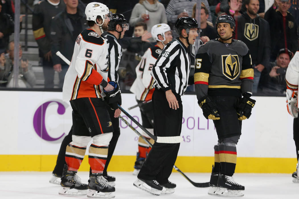 Vegas Golden Knights right wing Ryan Reaves (75) is moved away from Anaheim Ducks defenseman Er ...