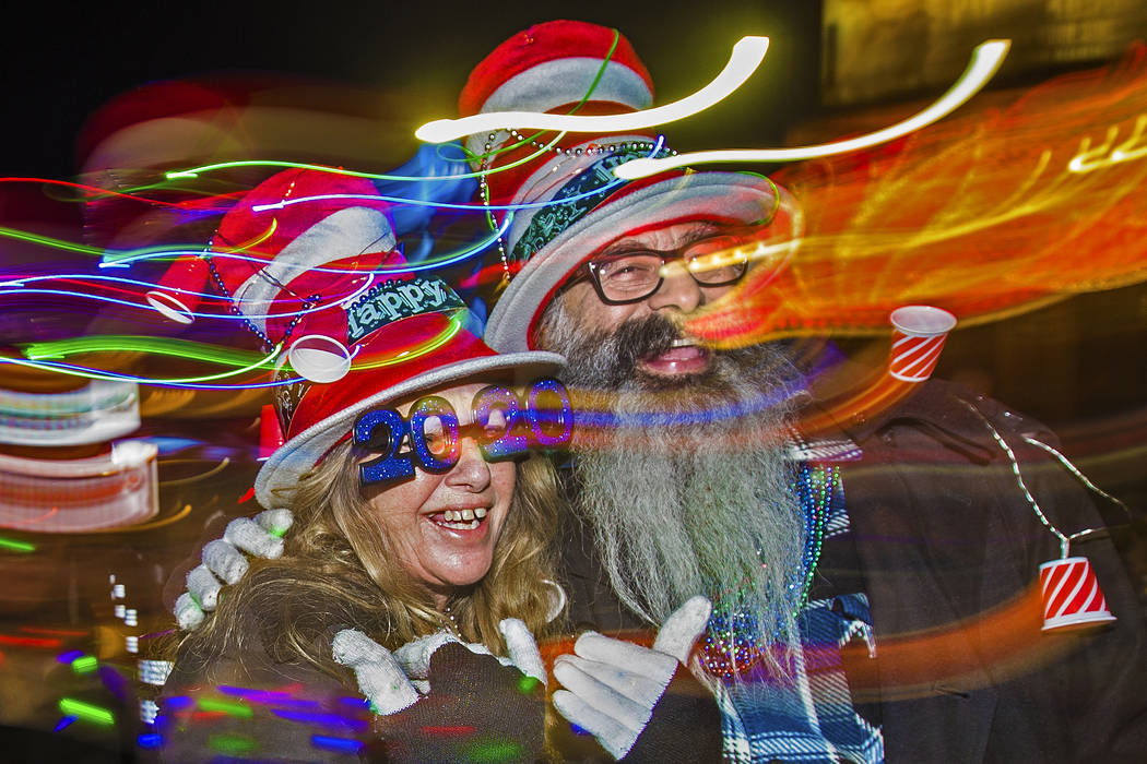 Trip, left, and Jess Barrios walk the Strip on Tuesday, Dec. 31, 2019, in Las Vegas. (Benjamin ...