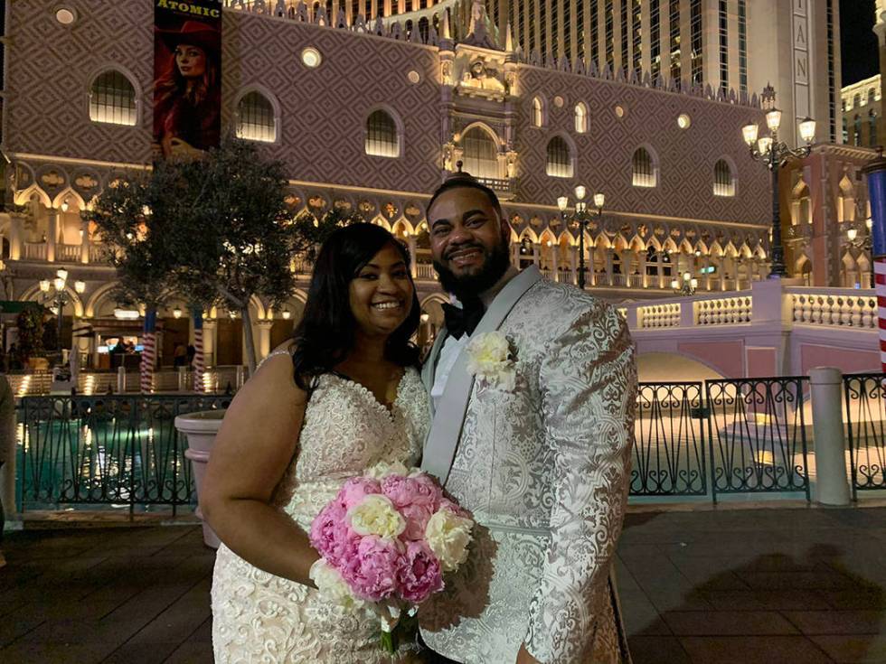 Sabrina and Chris Nettles pose for pictures in their wedding attire outside The Venetian on New ...