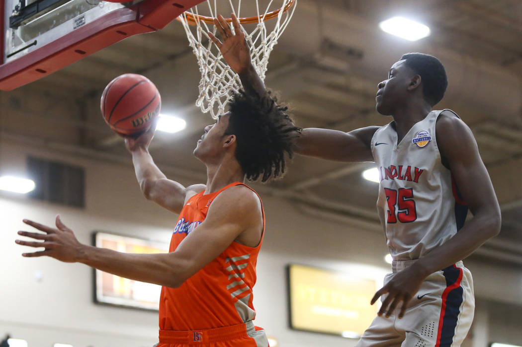 Bishop Gorman's Isaiah Cottrell goes to the basket in front of Findlay Prep's Alex Tchikou (35) ...
