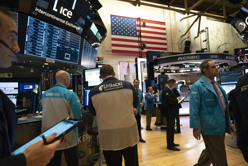 Stock traders work at New York Stock Exchange, Tuesday, Dec. 31, 2019. Stocks slipped globally ...