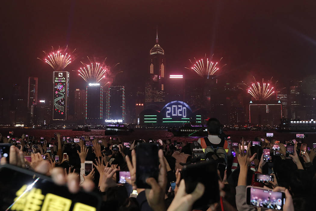 New Year's fireworks light up the sky as protesters gather during a demonstration in Hong Kong, ...