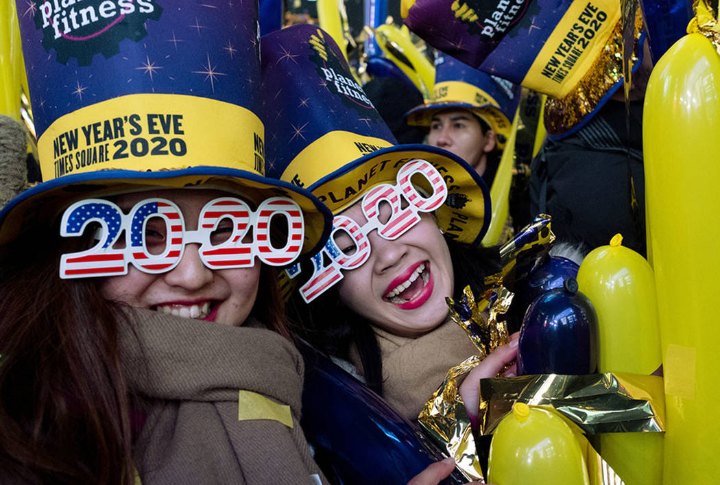 Revelers take part in New Year celebrations on Times Square in New York, Tuesday, Dec. 31, 2019 ...