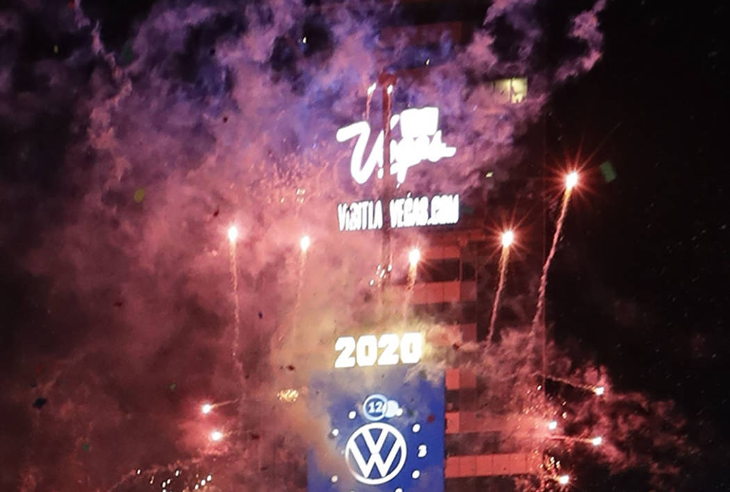 Confetti drops over the crowd as the clock strikes midnight during the New Year's celebration a ...