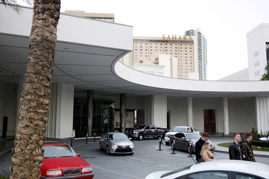 Individuals come and go at an entrance where there is free valet parking available at the Sahar ...